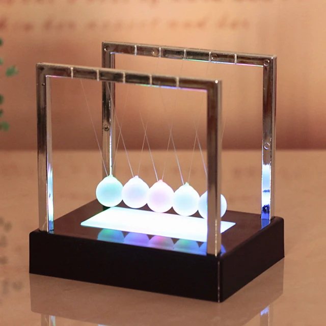 Image of a Newton's Cradle with glowing balls
